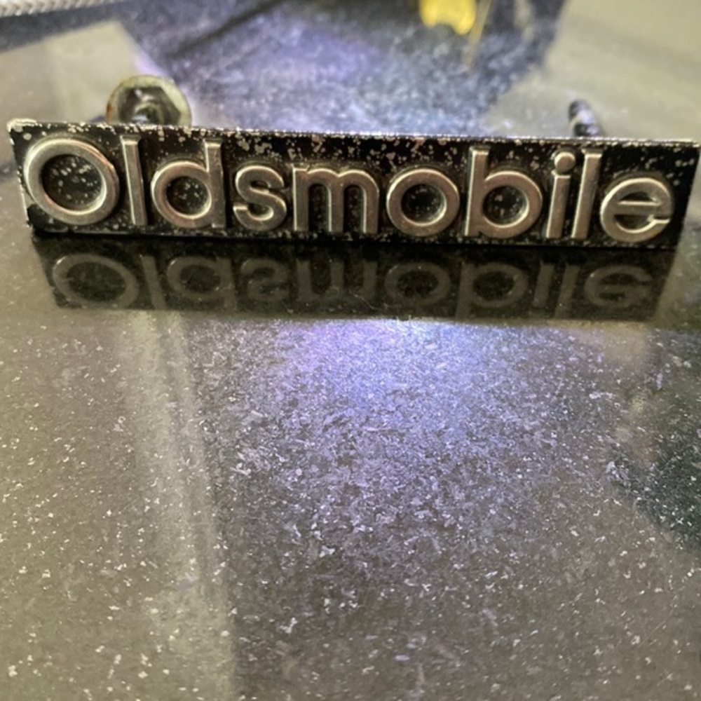 4” Oldsmobile metal logo silver, black background from an olds I used to…
